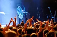 A musician performing on stage at a live show.