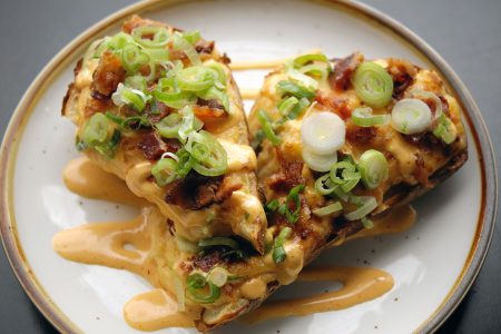 Close Up of Cheese and Onion Covered Potato Skins