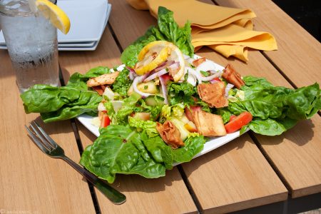 A fresh fatush salad on a sunny patio